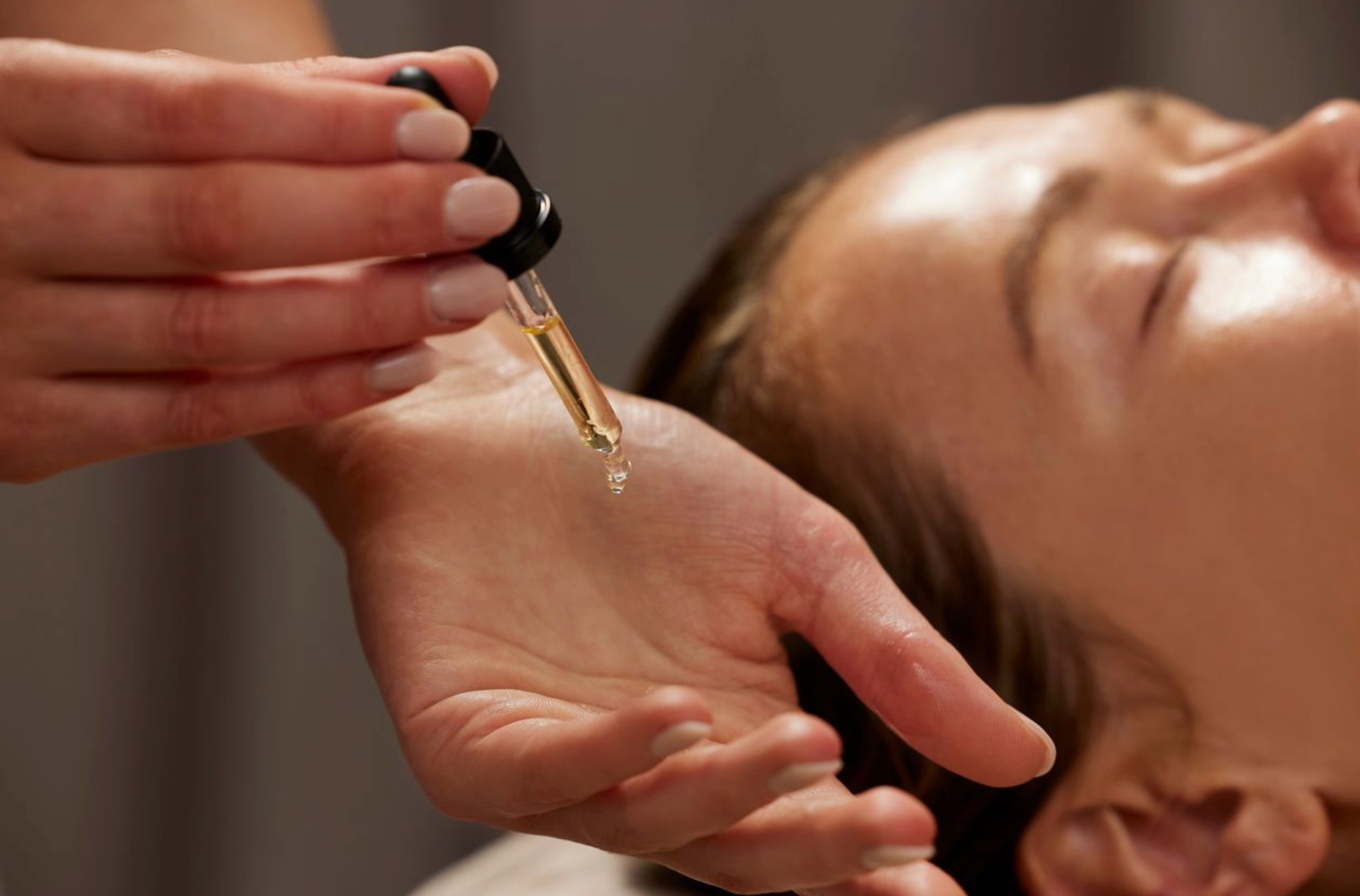 Applying a vitamin C serum as part of a morning skincare routine