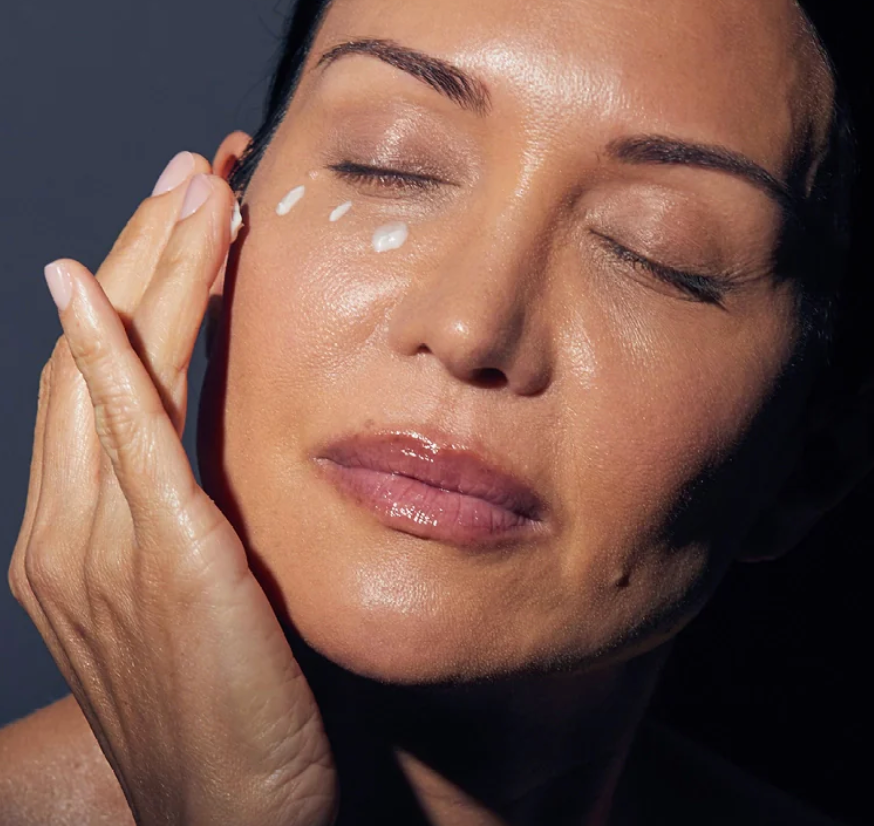 Woman applying Synergie Skin ImprovEyes Night Eye Cream - overnight eye treatment for dark circles and puffiness