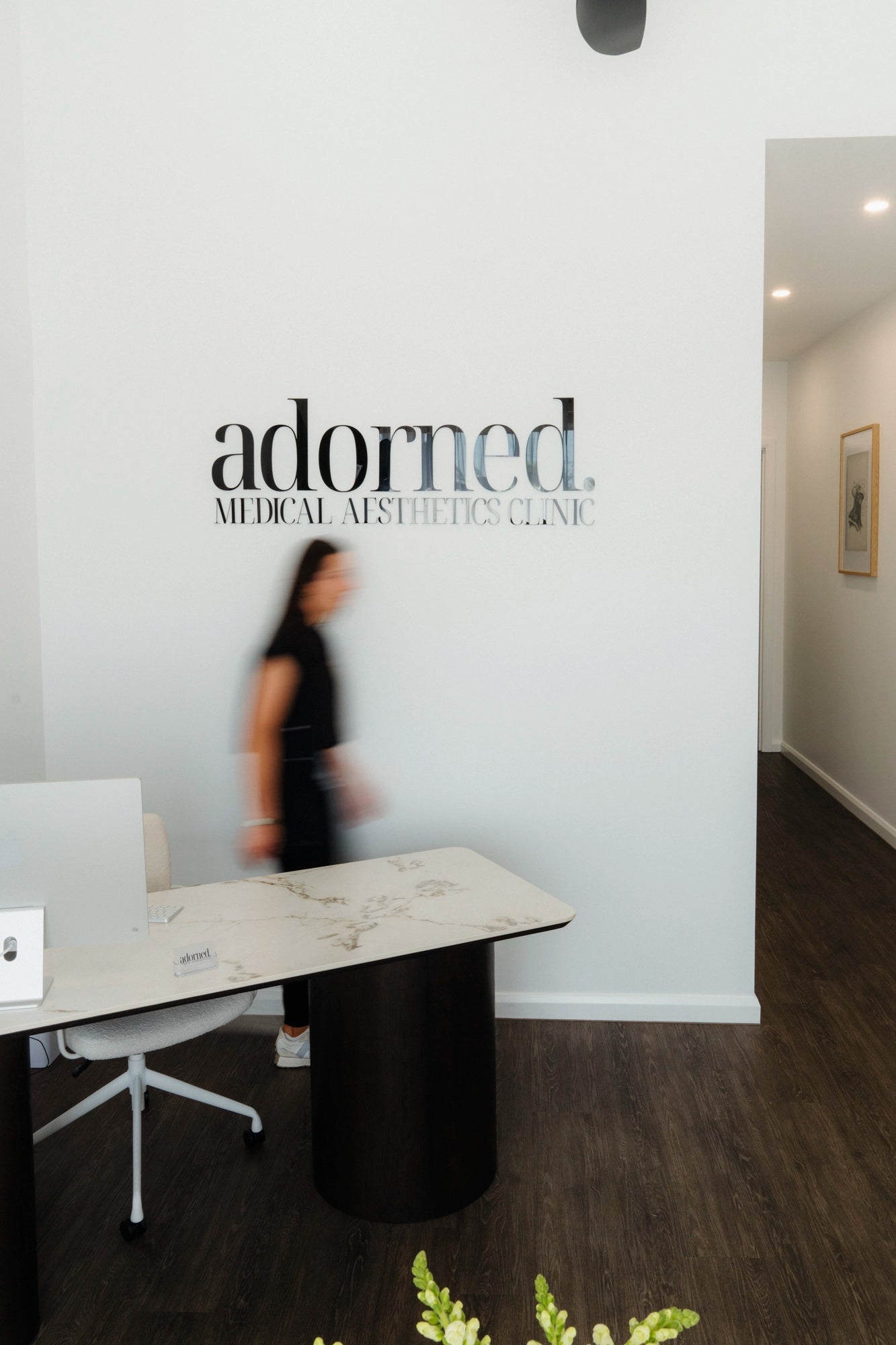 Nurse walking across modern clinic space