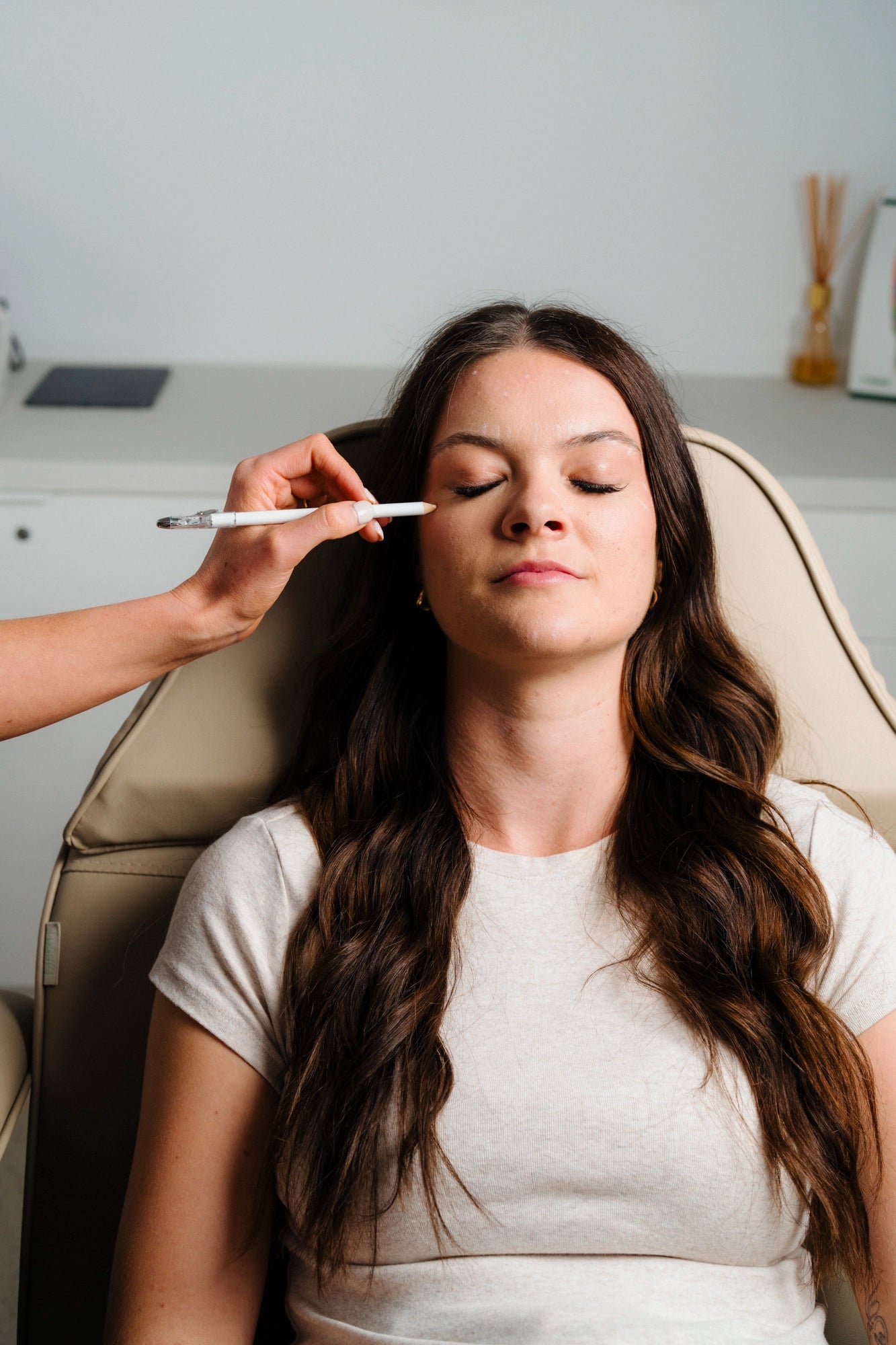 Facial mapping with cosmetic pencil during consultation in Toowoomba